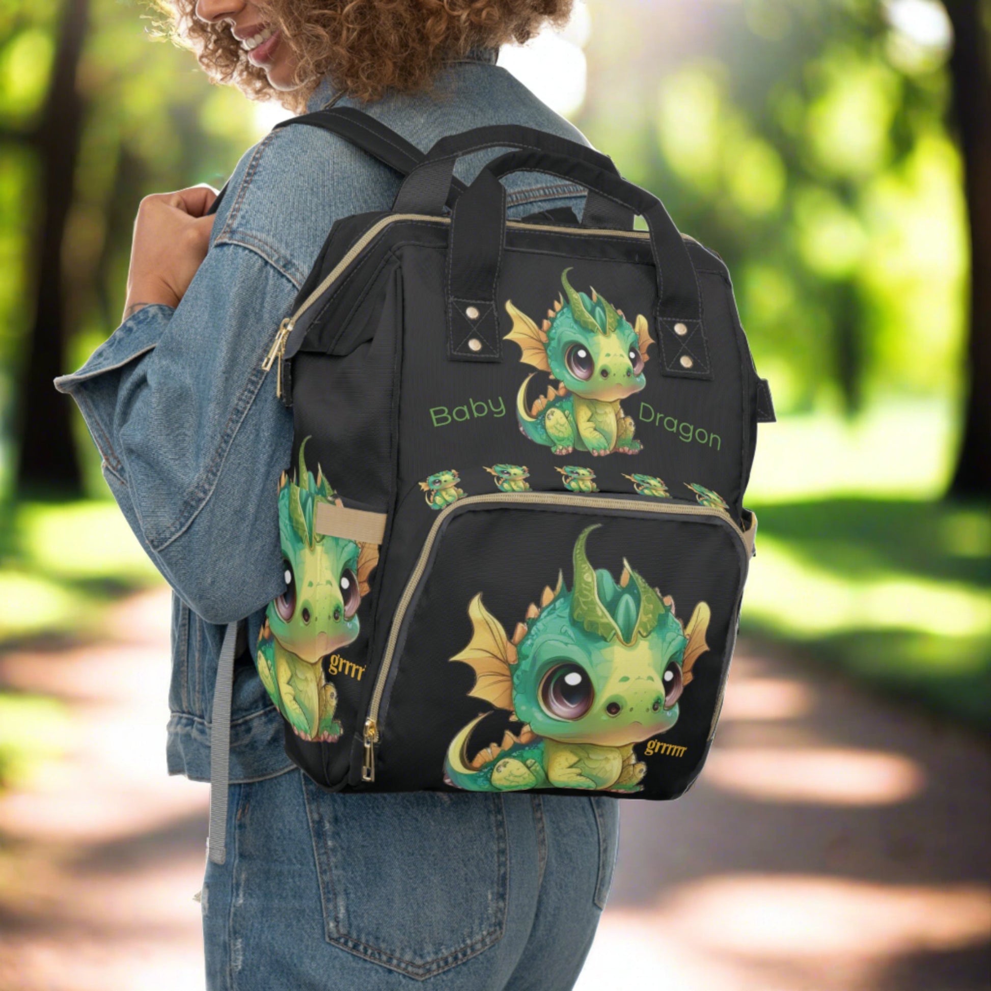 A black backpack/diaper bag with top handles too - a front zipped pocket with a baby Bobby dragon grrr on it - baby Bobby Dragon is on the top - front- back & sides - text Baby Dragon on the front - inside pockets & sturdy zipper and well made.