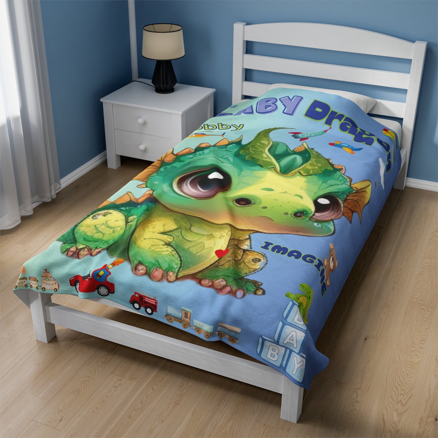 Our velveteen minky soft baby & kids blanket with a large green and gold adorable baby dragon Bobby in the center with boys toys all around, trains, trucks, dinosaurs, rocket ships and planes - the blanket color is gradient going from a beautiful light blue/green to a light blue every little boy will love