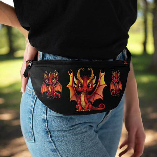 3 adorable baby red & gold dragons - one is a little spicy/naughty - are on the front of our darling anti theft fanny pack perfect for traveling - black washable material a solid quality zipper along the top of the bag with a long black silky adjustable strap with a sturdy clip. Inside is a mesh net in the middle of a generous bag a zippered pocket 3 cc slots - outside is another smaller zippered pocket for quick access - baby dragons are on the top of the bag - a black solid back. 