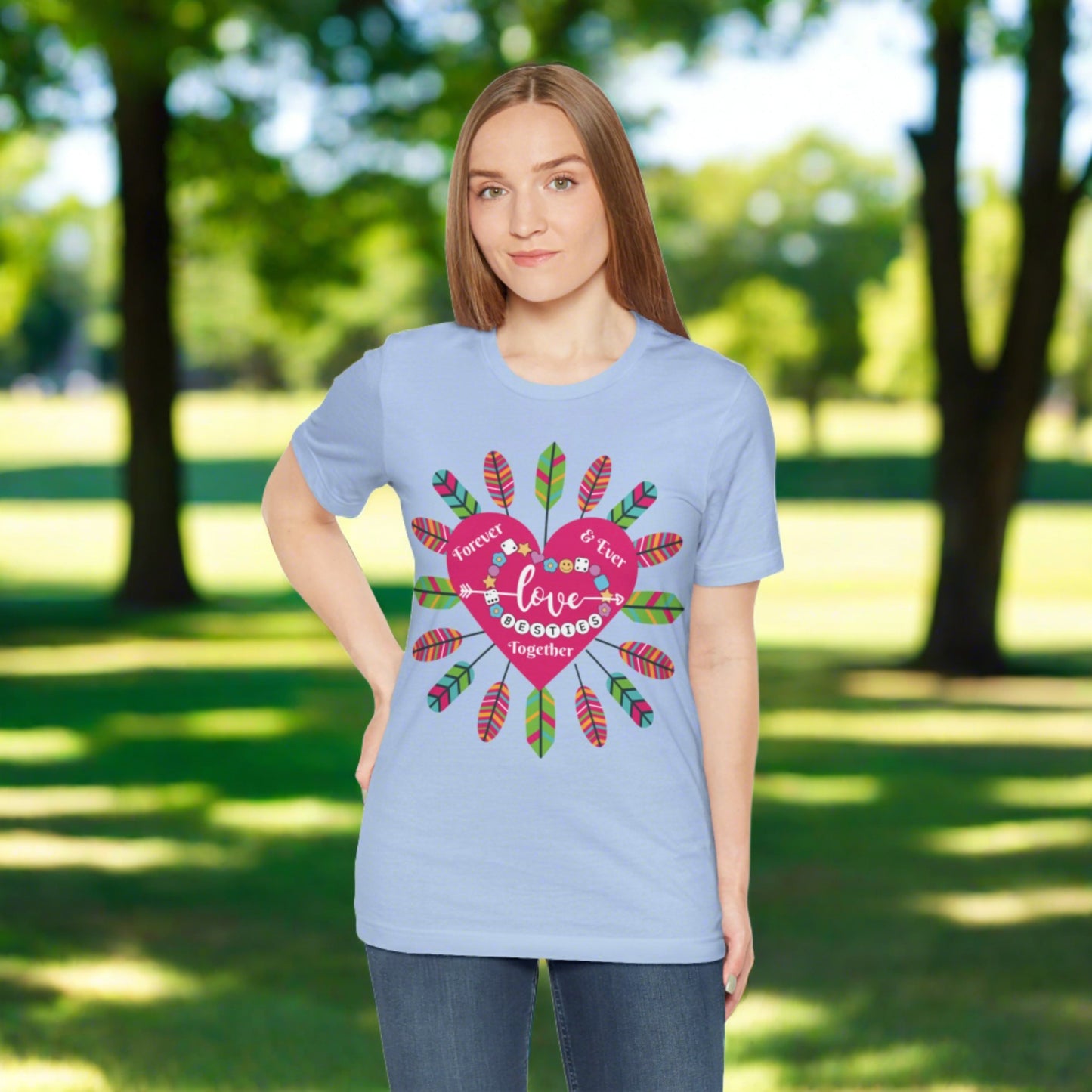inside a pink heart is the message Besties Forever Together Love is the message on this light blue tee with a feather dream catcher surrounding the shape of a pink heart
