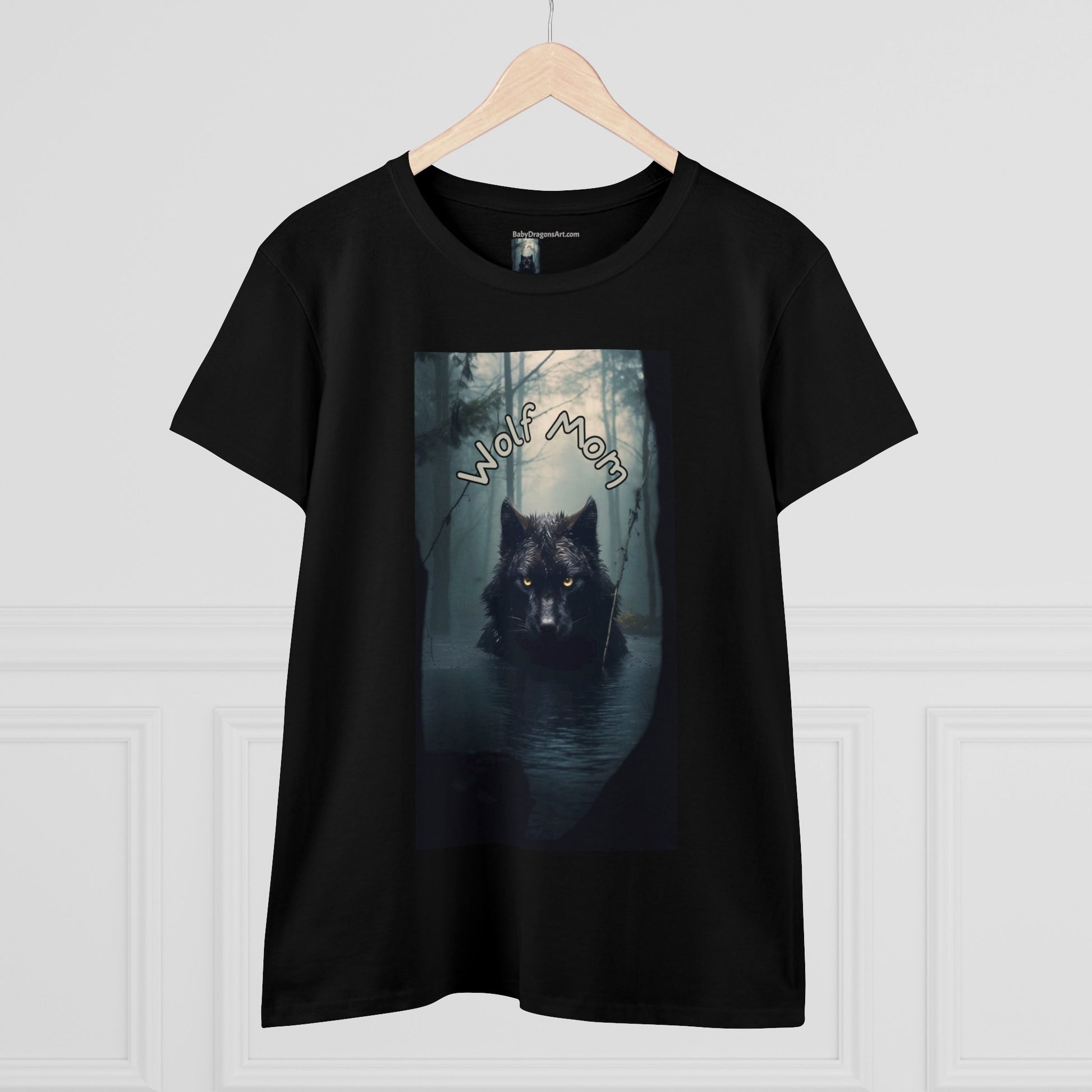 A black wolf with yellow eyes stares directly at you from the center of the tee - dead calm - a misty dark forest is behind the imposing black alpha wolf - the text Wolf Mom sits a few inches above the wolves ears - stunning!