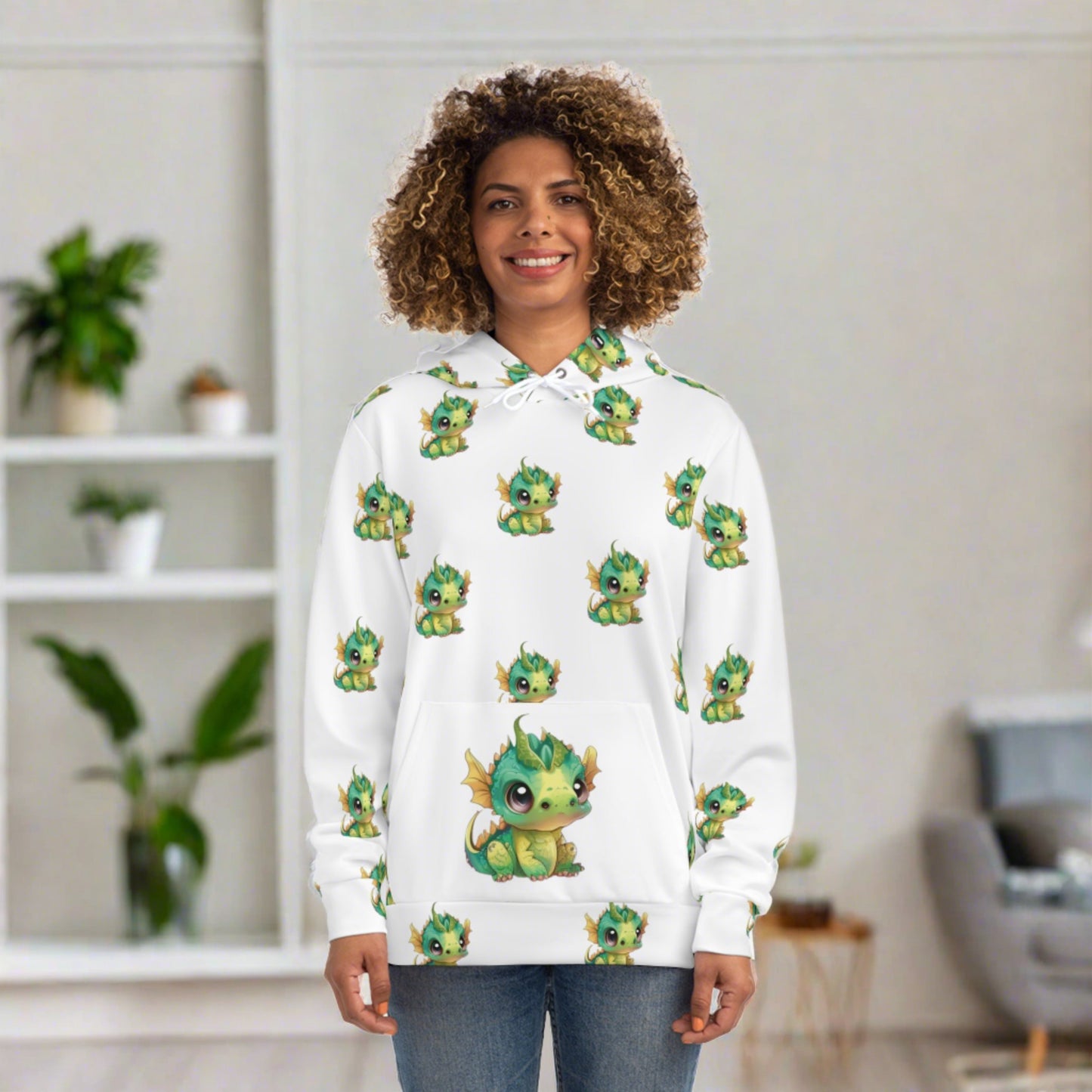 On a hoodie with a large front pocke sits a cute baby Bobby Dragon in greens yellows and a green baby horn - he is all over the hoody about 3 inches tall and 3 inches away from each other on this all over print hoody.