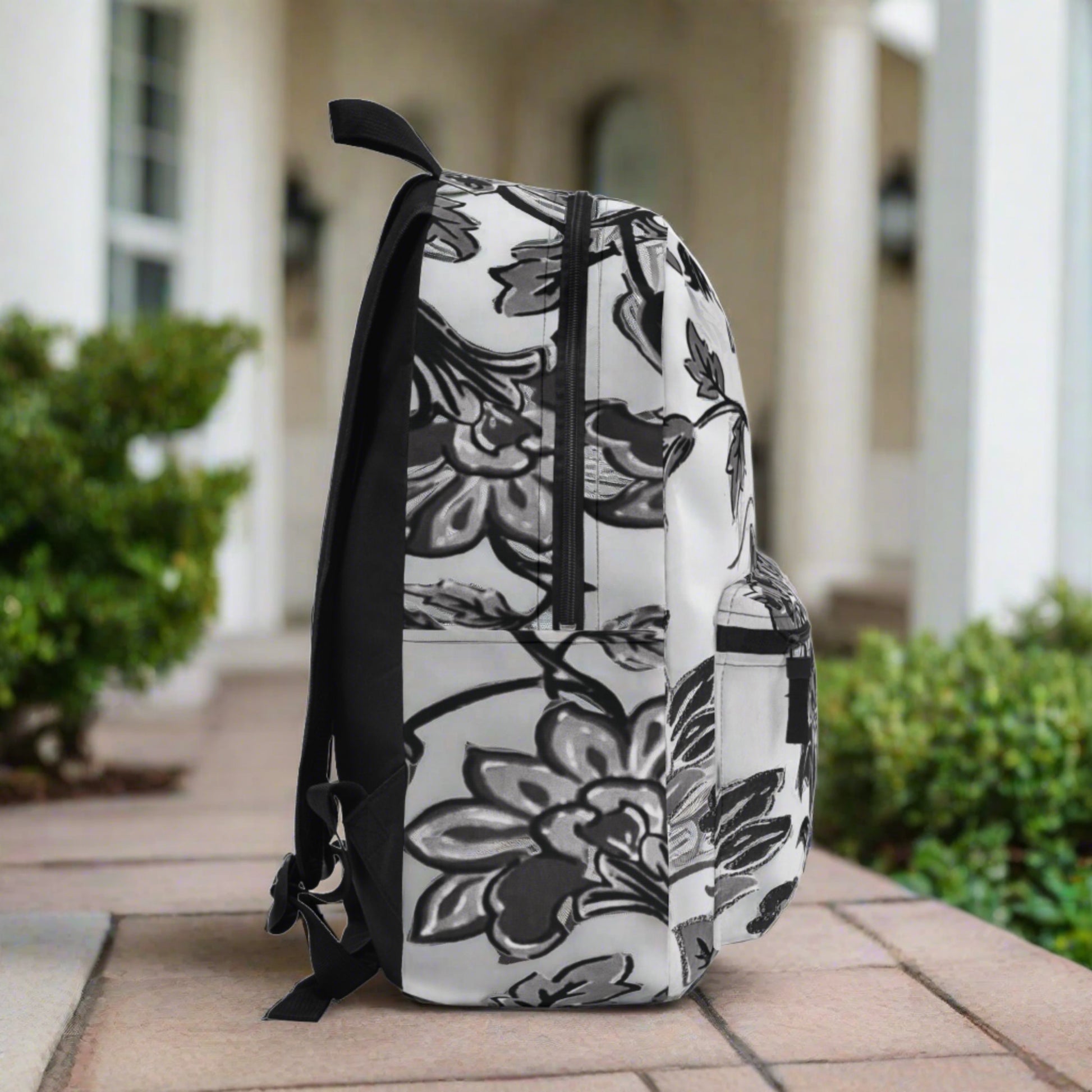 Black & white flowers are all over printed bold & clear into the durable canvas material ... beautiful and sturdy backpack with compartments and zippered front pocket - flowered decorative black & white pattern for retro lovers.