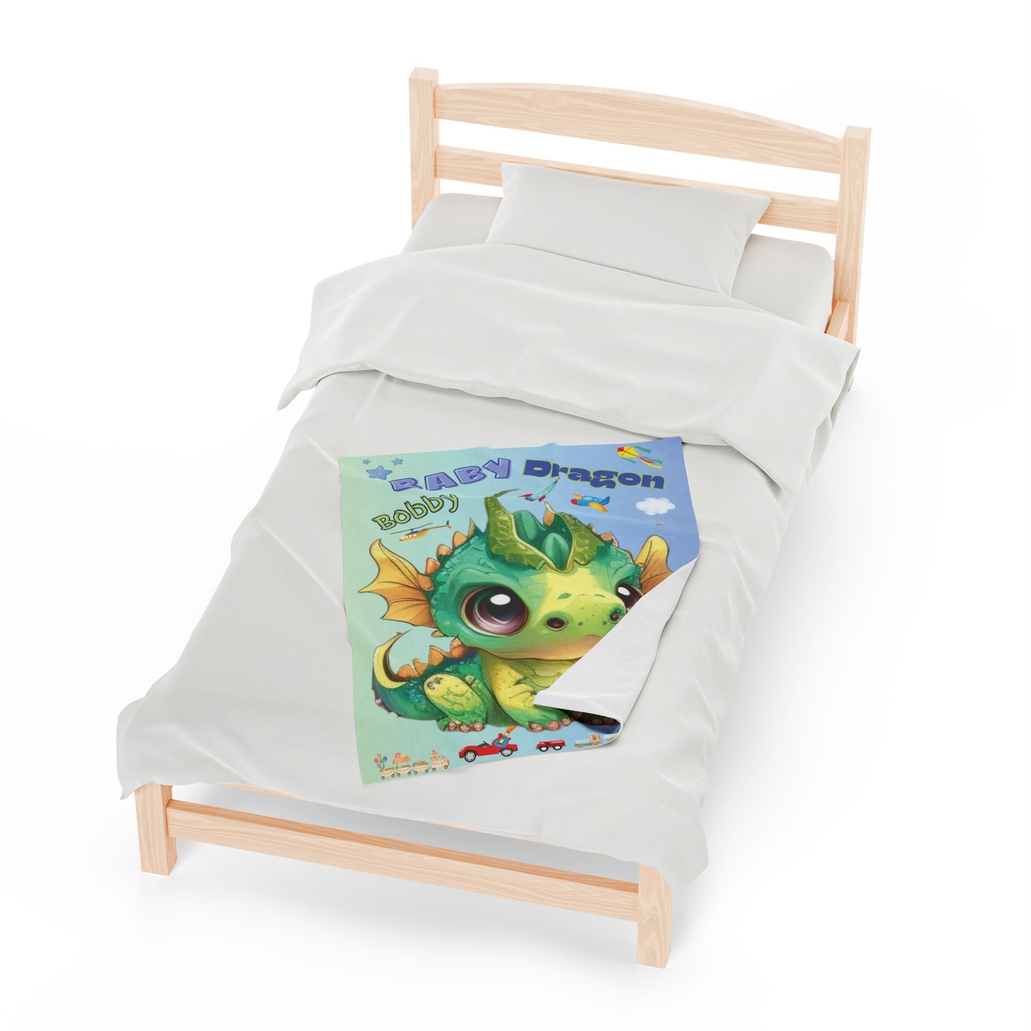 Our velveteen minky soft baby & kids blanket with a large green and gold adorable baby dragon Bobby in the center with boys toys all around, trains, trucks, dinosaurs, rocket ships and planes - the blanket color is gradient going from a beautiful light blue/green to a light blue every little boy will love