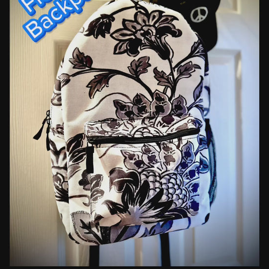 A Video Up Close Of Backpack - Black & white flowers are all over printed bold & clear into the durable canvas material ... beautiful and sturdy backpack with compartments and zippered front pocket - flowered decorative black & white pattern for retro lovers.